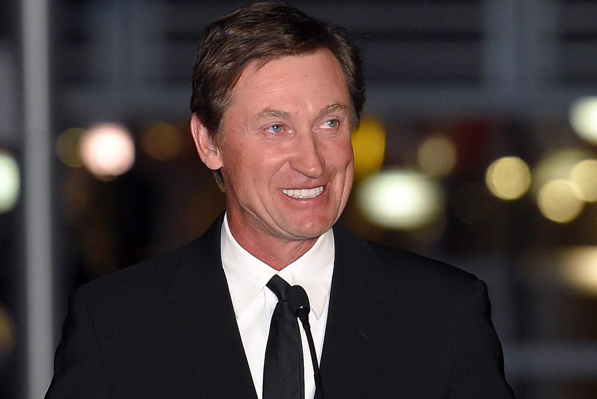 In this March 7, 2015 file photo, former Kings player Wayne Gretzky speaks to the crowd at a statue unveiling for former Kings left wing Luc Robitaille prior to an NHL hockey game against the Pittsburgh Penguins in Los Angeles. 