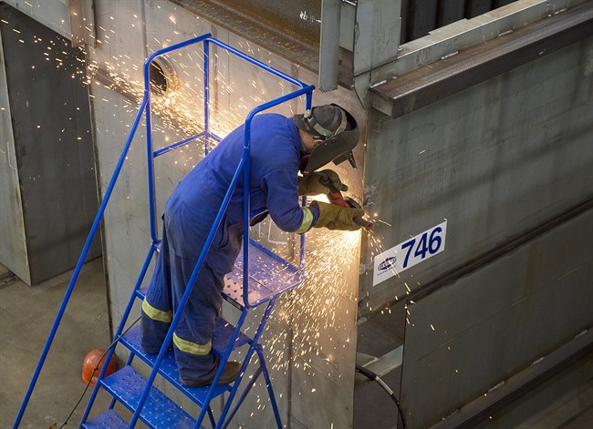 A worker grinds a component at the Irving Shipbuilding facility in Halifax on Monday, June 13, 2016.