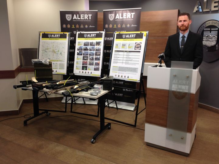 Members of ALERT showcase some of the items seized in an investigation into Edmonton's Hells Angels motorcycle club.