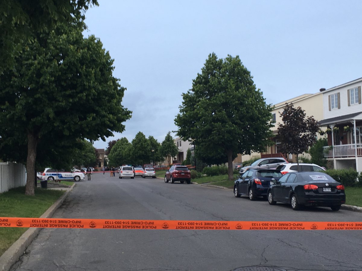 Montreal police set a perimeter around a woman's home in Pointe-aux-Trembles after she was mauled by a dog, Wednesday, June 8, 2016.