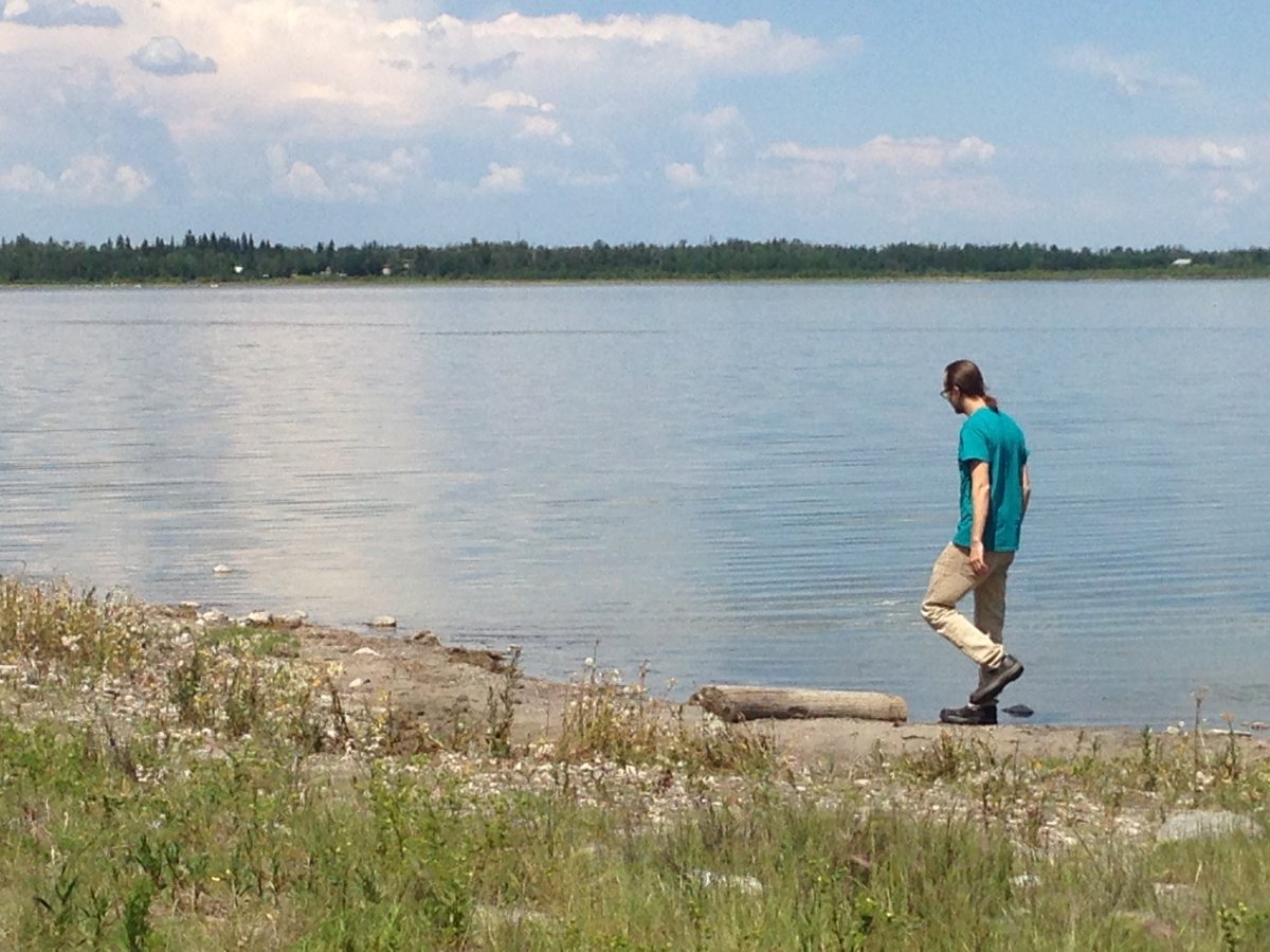 Andrew Carlson looks for blue-green algae at Hastings Lake.