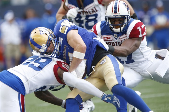 Winnipeg Blue Bombers' Weston Dressler gets stopped by Montreal Alouettes' Jonathon Mincy and Billy Parker during the first half of last week's game in Winnipeg.