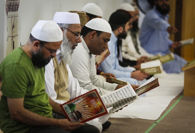 Men pray at a mosque in Calgary, Alta., Sunday, June 5, 2016.