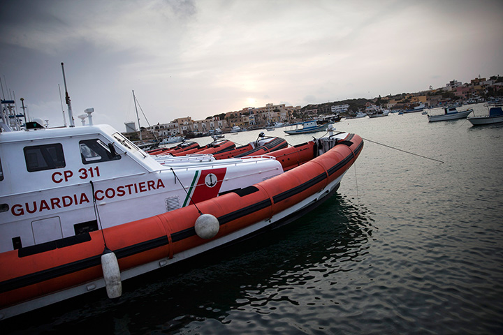 Coastguard vessels float in the harbour on April 24, 2015 in Lampedusa, Italy. 