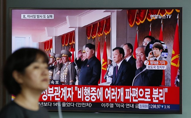 A woman walks by a public TV screen showing the North Korea's leader Kim Jong Un at the Seoul Train Station in Seoul, South Korea, Wednesday, June 22, 2016.