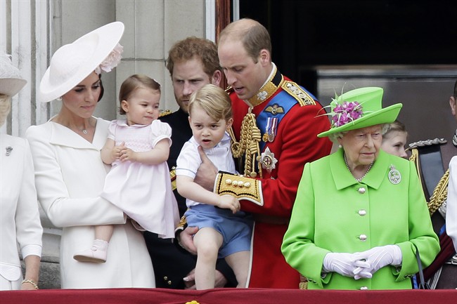 Britain’s Queen Elizabeth II, right, with Prince William holding Prince George, centre, and Kate, Duchess of Cambridge holding Princess Charlotte, left, on the balcony during the Trooping The Colour parade at Buckingham Palace, in London, Saturday, June 11, 2016.