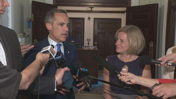 Bank of England Governor Mark Carney speaks to reporters along with Premier Rachel Notley in Edmonton on June 6, 2016.