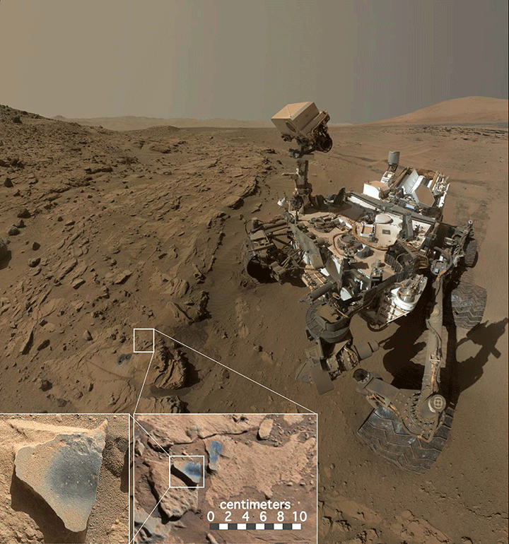 In front of the Curiosity rover are two holes from the rover’s sample-collection drill and several dark-toned features that have been cleared of dust (see inset images). These flat features are erosion-resistant fracture fills that are composed of manganese oxides, which require abundant liquid water and strongly oxidizing conditions to form.