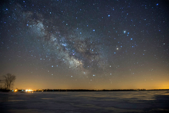 The Milky Way stretches across Lake Ontario at Sandbanks Provincial Park, about 60 km southwest of Kingston. 