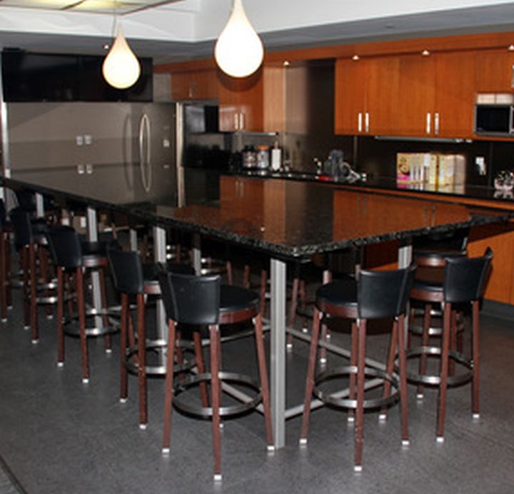 A massive granite table and 14 chairs which lived in the Edmonton Oilers players lounge are up for auction.