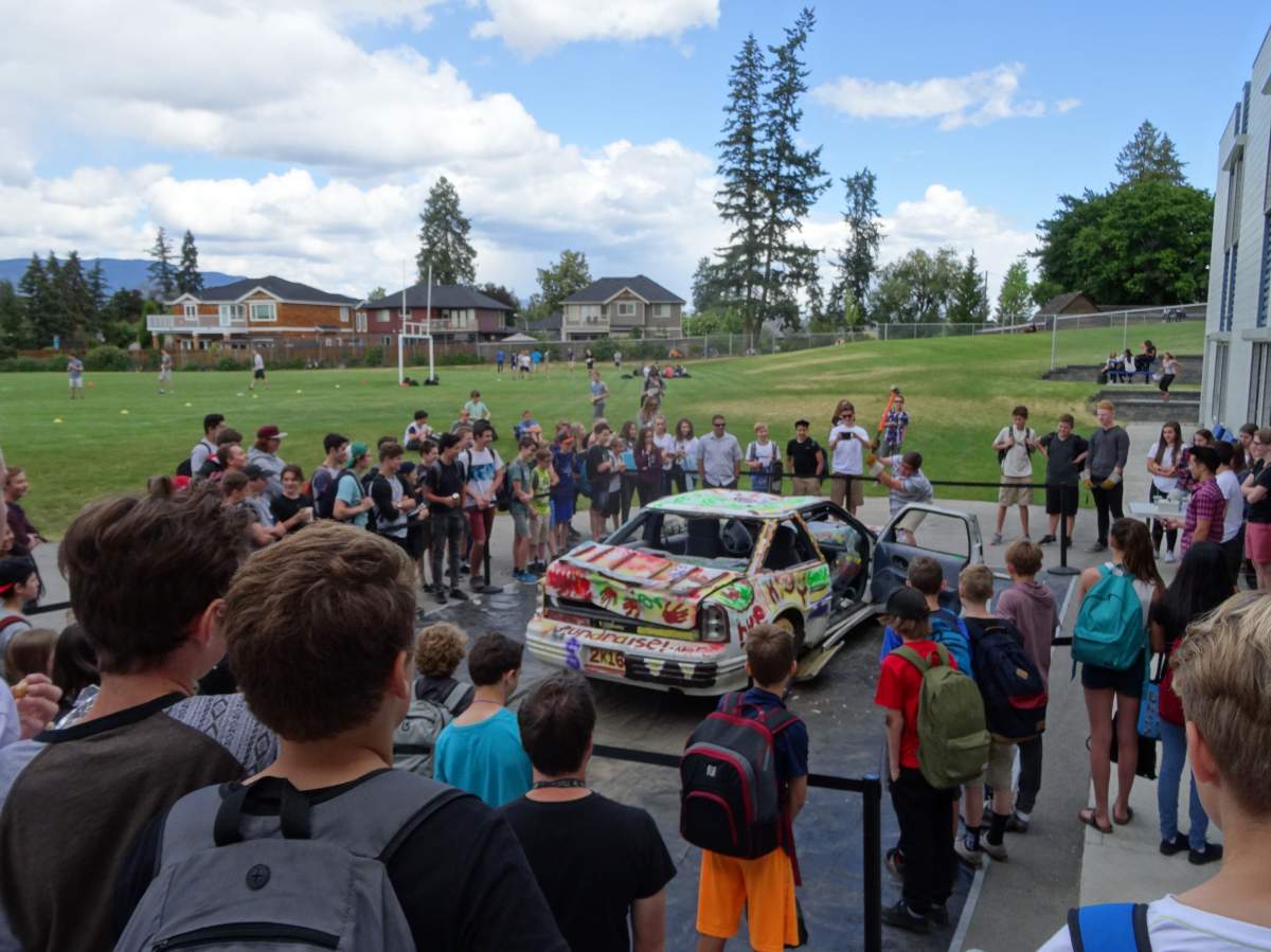 A car being smashed at Okanagan Mission Secondary school to raise money for Fort McMurray. 