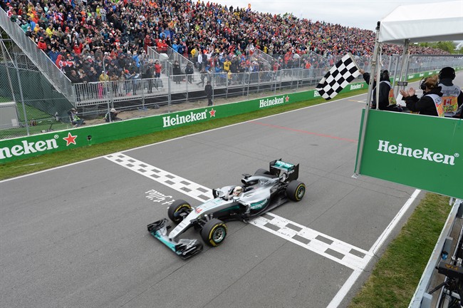 Mercedes driver Lewis Hamilton of Great Britain crosses the finish line to win the Canadian Grand Prix. 
