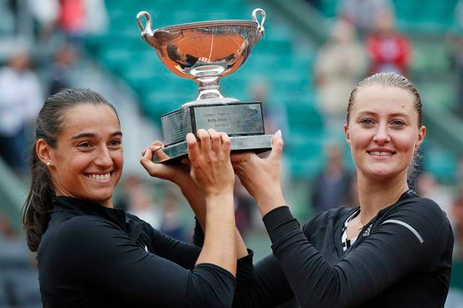 Caroline Garcia, left, and Kristina Mladenovic of France celebrate with the trophy after winning the women's doubles final of the French Open tennis tournament.