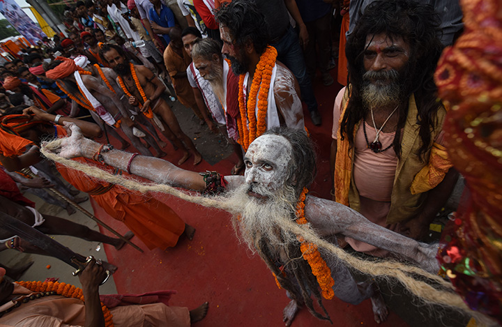 An Indian Hindu sadhu (holy man) dances in a religious procession on the eve of the annual Ambubachi festival at the Kamakhya temple in Guwahati on June 21, 2016.