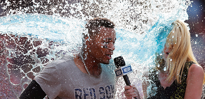 Boston Red Sox’s Xander Bogaerts and TV reporter Guerin Austin are doused following the game against the Chicago White Sox at Fenway Park, Thursday, June 23, 2016, in Boston.