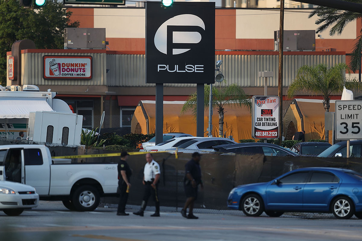 Law enforcement officials investigate near the Pulse Nightclub where Omar Mateen killed at least 49 people on June 13, 2016 in Orlando, Florida. 