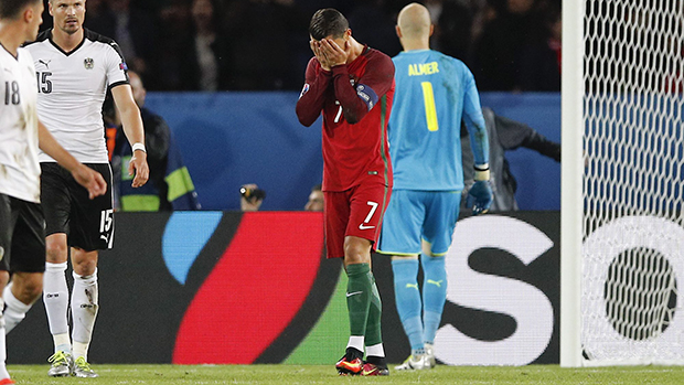 Portugal's Cristiano Ronaldo, center, holds his face after missing a penalty kick, during the Euro 2016 Group F soccer match between Portugal and Austria at the Parc des Princes stadium in Paris, France, Saturday, June 18, 2016. (AP Photo/Christophe Ena)