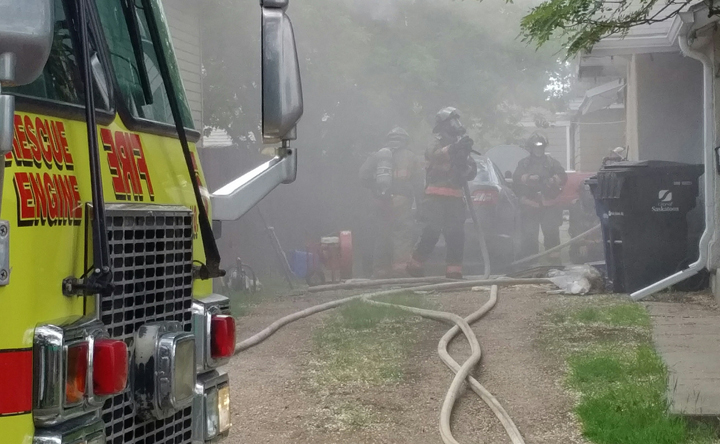 Saskatoon firefighters work their way through heavy smoke, intense heat to deal with a house fire.