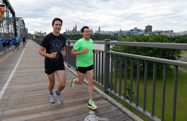 Prime Minister Justin Trudeau and Mexican President Enrique Pena Nieto run across the Alexandra Bridge from Ottawa to Gatineau, Quebec on Tuesday, June 28, 2016.