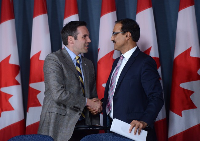 Amarjeet Sohi, Minister of Infrastructure and Communities, right, is joined by Currie Dixon, Minister of Community Services and Minister of the Public Service Commission for the Government of Yukon during a an infastructure annoucement at the National Press Theatre in Ottawa on Wednesday, June 22, 2016. THE CANADIAN PRESS/Sean Kilpatrick.