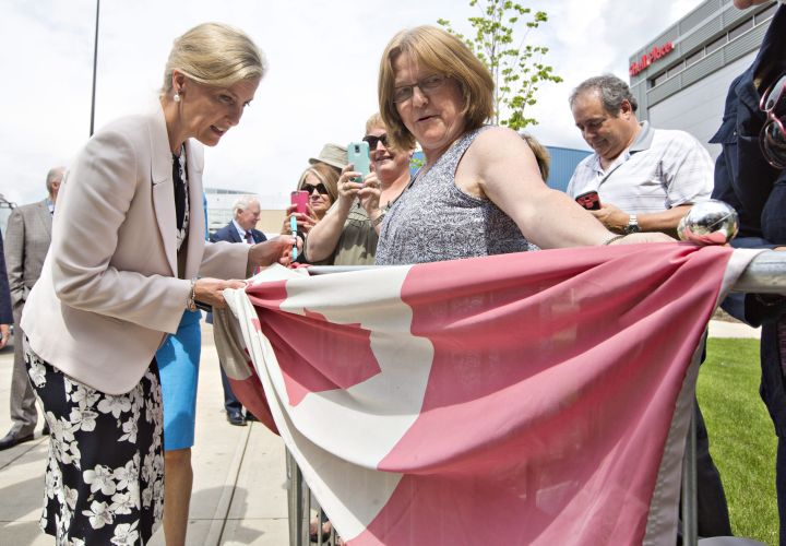 Sophie, Countess of Wessex signs a flag of a resident of Fort McMurray, during a visit to Fort McMurray Alta, on Friday June 24, 2016.