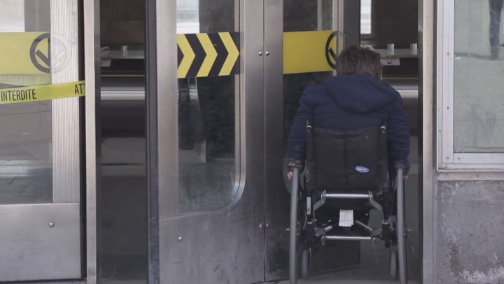 A person with reduced mobility enters a Montreal metro station.