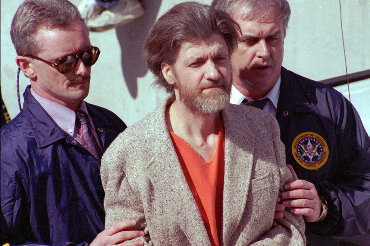 In this April 4, 1996 file photo, Unabomber Theodore John Kaczynski is flanked by federal agents as he is led to a car from the federal courthouse in Helena, Mont. 