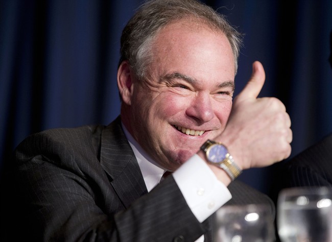 In this Feb. 4, 2016, file photo, Sen. Tim Kaine, D-Va., gives a 'thumbs-up' as he takes his seat at the head table for the National Prayer Breakfast in Washington.