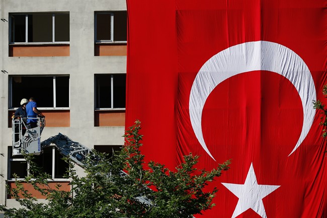 The Turkish flag is seen draped over a building in Istanbul. (AP Photo/Emrah Gurel).