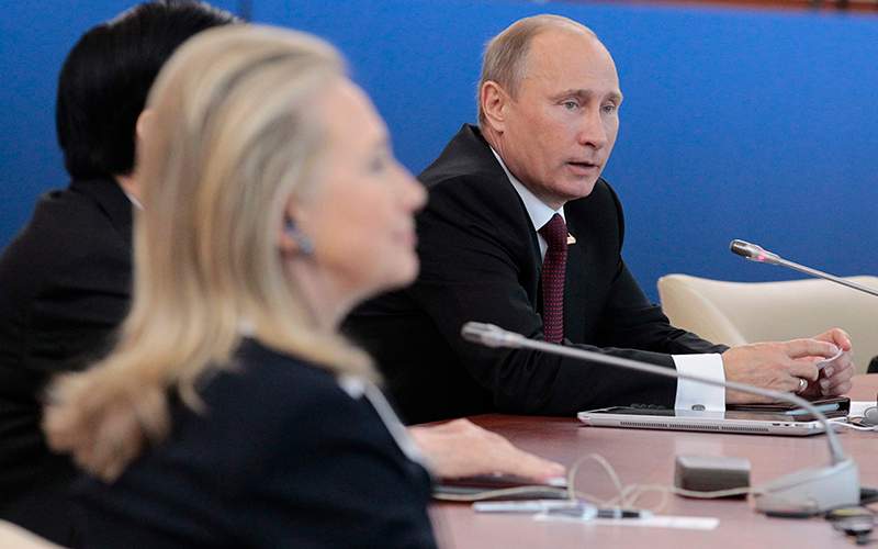 Russian President Vladimir Putin, right, addresses the leaders meeting as U.S. Secretary of State Hillary Rodham Clinton listens at the APEC summit in Vladivostok, Russia.