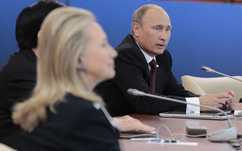 Russian President Vladimir Putin, right, addresses the leaders meeting as U.S. Secretary of State Hillary Rodham Clinton listens at the APEC summit in Vladivostok, Russia.