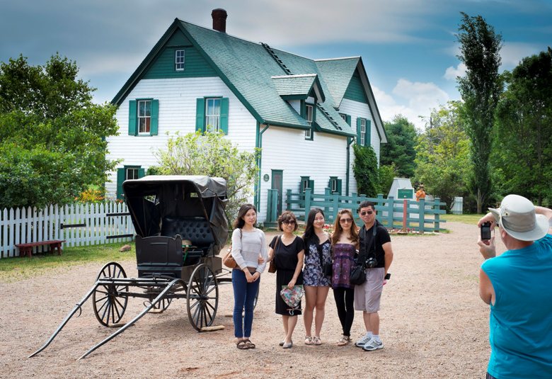 Tourists pose for a picture at Green Gables Heritage Place on July18, 2013. 