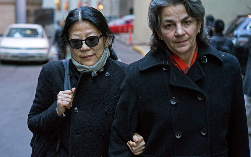 Sheri Yan, CEO of Global Sustainability Foundation, left, leaves federal court in New York Wednesday, Jan. 20, 2016, after she plead guilty in connection with a scheme to bribe ex-UN General Assembly President John Ashe. 