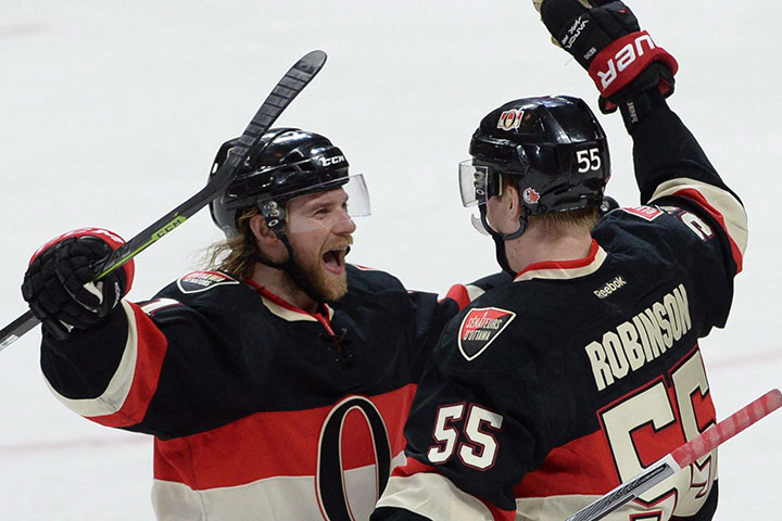 Ottawa Senators right wing Buddy Robinson , right, celebrates his first NHL goal with teammate Ottawa Senators defenseman Michael Kostka during second period NHL hockey action in Ottawa on Thursday, April 7, 2016.