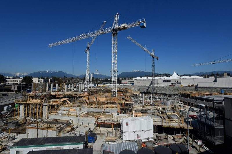 A view of a massive residential, shopping and entertainment complex under construction next to the Brentwood Mall (at right, rear)  in Burnaby, British Columbia on April 1, 2016.  Rapidly rising real estate prices are fueling a construction boom in greater Vancouver. THE CANADIAN PRESS IMAGES/Don Denton.