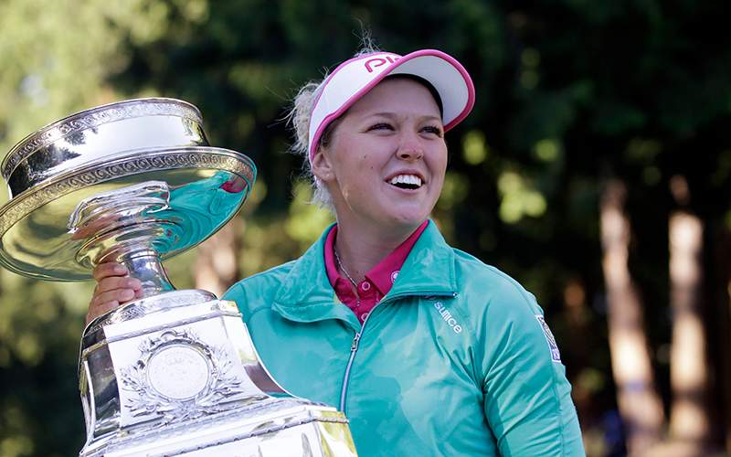 Brooke Henderson, of Canada, holds the championship trophy after winning the Women's PGA Championship golf tournament at Sahalee Country Club in Sammamish, Wash. Henderson has come a long way since her win last year in Portland. She's ranked No. 2 in the world and has a major victory as she looks to defend her title at the Portland Classic. 