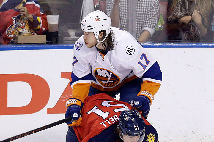 Florida Panthers defenseman Brian Campbell (51) is checked by New York Islanders left wing Matt Martin (17) during the first period of Game 5 of an NHL hockey first-round Stanley Cup playoff series, in an April 22, 2016 file photo taken in Sunrise, Florida.