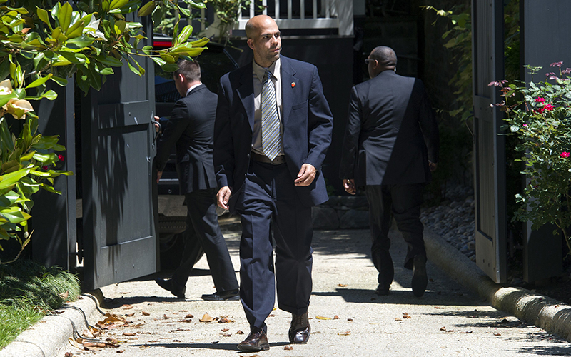 A Secret Service agent stands guard while two other agents close a gate after a Secret Service vehicle arrived at the home of Democratic presidential candidate Hillary Clinton in Washington, Saturday, July 2, 2016. 
