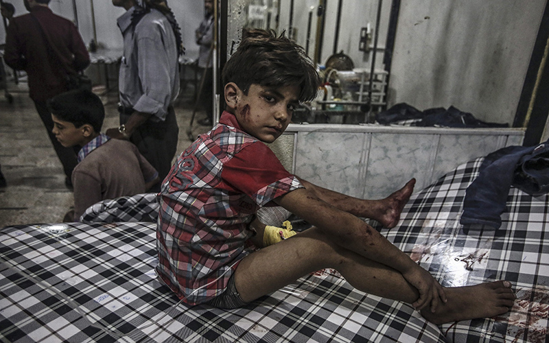 A Syrian boy receives first aid in a field hospital following airstrikes on 09 July 2016. 