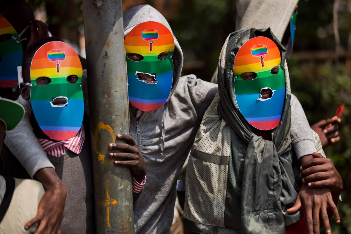 In this Monday, Feb. 10, 2014 file photo, Kenyan gays and lesbians and others supporting their cause wear masks to preserve their anonymity as they stage a rare protest. Human Rights Watch is urging an end to "forced anal examinations" with a report documenting them in eight countries, mostly in Africa, saying the practice is based on flawed ideas about supposedly proving homosexual conduct. 