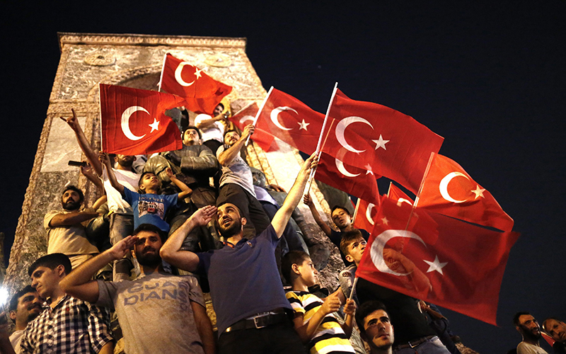 Supporters of Turkish President Recep Tayyip Erdogan shout slogans and hold flags during a demonstration, against the failed Army coup attempt, at Taksim Sqaure, in Istanbul, Turkey, 16 July 2016. 