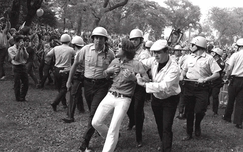 Police lead a demonstrator from Grant Park during demonstrations that disrupted the Democratic National Convention in Chicago in this August 1968 file photo. 