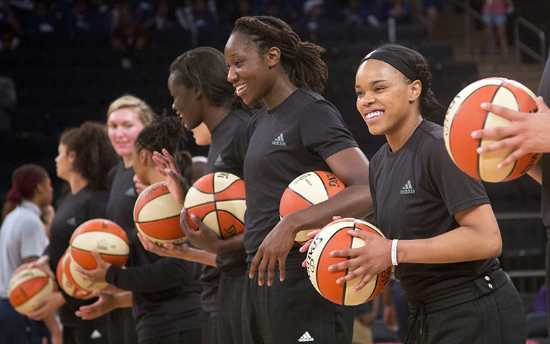 Members of the New York Liberty basketball team await the start of a game against the Atlanta Dream in New York. 