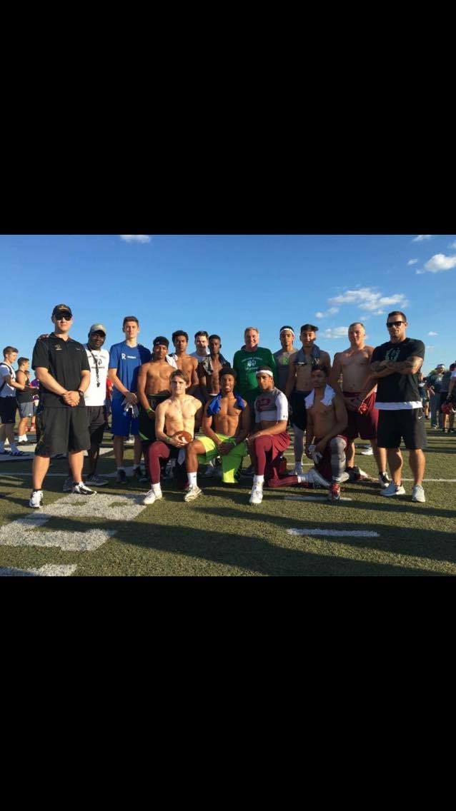 Recruit ready athletes and their coaches pose for a picture during a seven-on-seven session