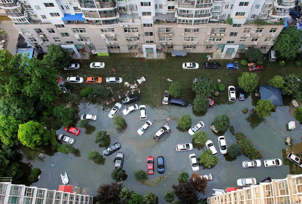 Automobiles are seen flooded at a neighbourhood in Wuhan, Hubei province, China July 9, 2016. Picture taken July 9, 2016.