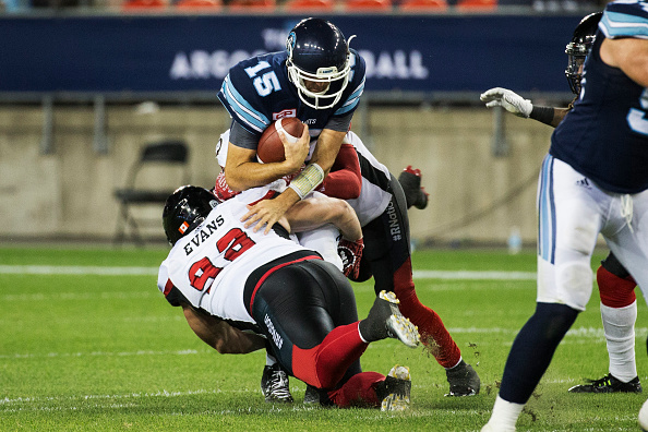 Toronto Argonauts quarterback Ricky Ray (15) gets tackled by Ottawa Redblacks defensive lineman Zack Evans (92) during the second half of their Canadian Football League game at BMO Field in Toronto, on July 13, 2016. (Melissa Renwick/Toronto Star via Getty Images).