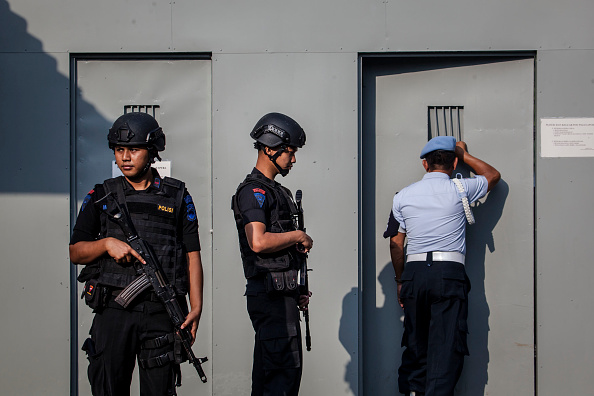 Indonesian police stand guard at Wijayapura port, the entrance gate to Nusakambangan prison, ahead of a third round of drug executions on July 28, 2016 in Cilacap, Central Java, Indonesia. According to reports, Indonesia is likely to resume executions of 14 prisoners on death row this week. Fourteen prisoners, including inmates from from Nigeria, Pakistan, India, South Africa, and four Indonesians, have been moved to isolation holding cells at Nusa Kambangan, off Central Java.  (Photo by Ulet Ifansasti/Getty Images).