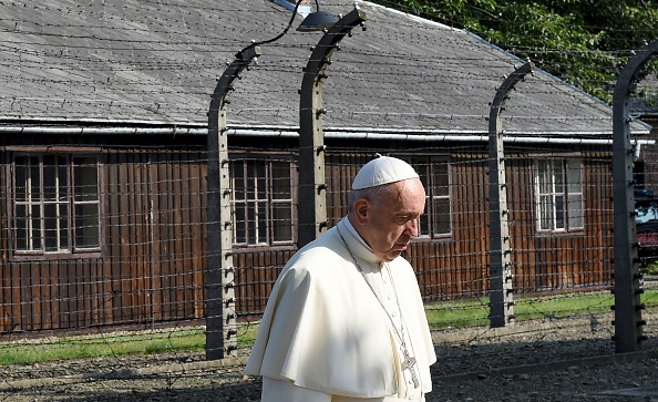 Pope Francis  walks through the entrance of the former Nazi death camp of Auschwitz in Oswiecim on 29 July, 2016.