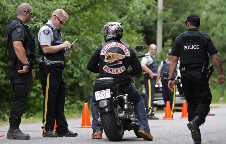 RCMP officers stop an Alberta member of the Hells Angels motorcycle gang at a roadblock during the 2008 Canada Run in Langley, B.C.