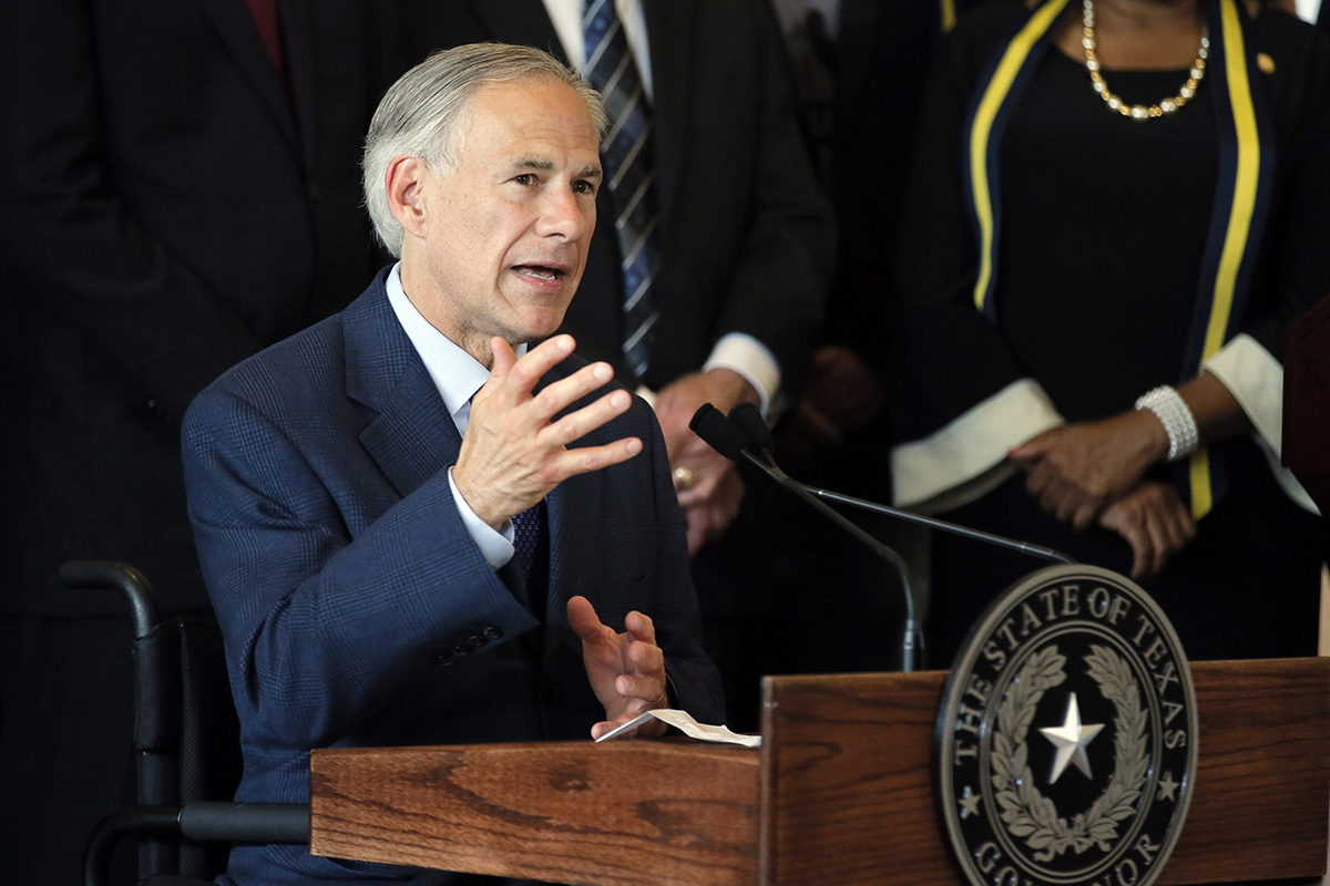 In this Friday, July 8, 2016 file photo, Texas Gov. Greg Abbott, right, responds to questions about the police shootings during a news conference at City Hall in Dallas.